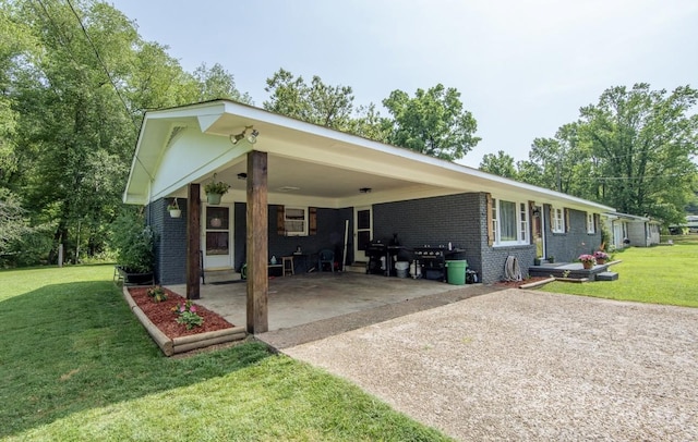 5011 Sunny Acres Dr, Waynesboro, TN 38485 - view of front of house with brick siding, an attached carport, concrete driveway, and a front yard