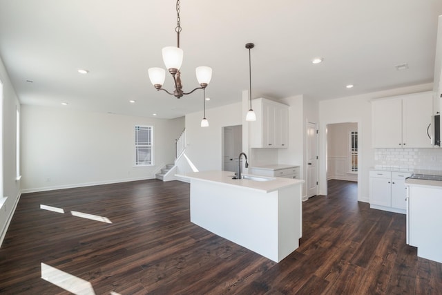4016 Rampart Way, Spring Hill, TN 37174 - kitchen featuring dark wood-style floors, stainless steel microwave, decorative backsplash, light countertops, and recessed lighting
