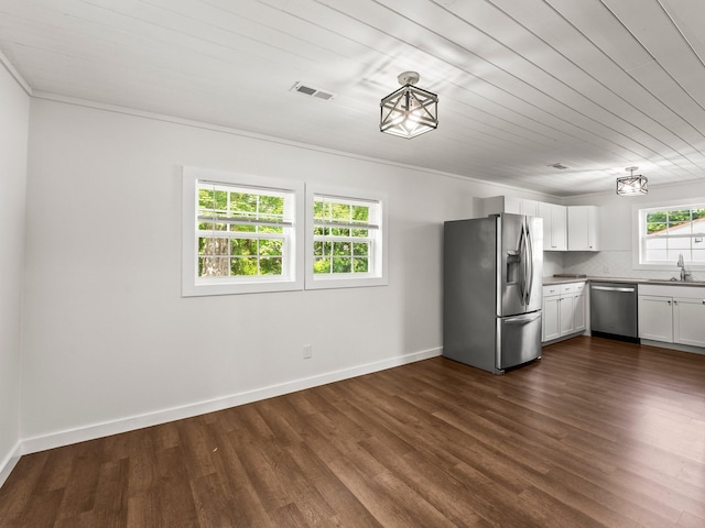 227 Shady Grove Rd, Manchester, TN 37355 - kitchen with stainless steel appliances, dark wood finished floors, white cabinetry, backsplash, and ornamental molding
