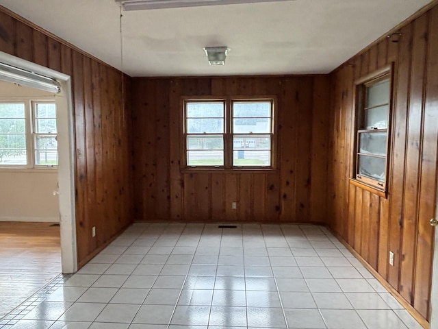 902 Mcarthur St, Manchester, TN 37355 - unfurnished room with wood walls, plenty of natural light, and light tile patterned floors