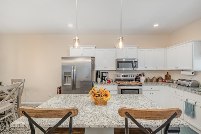 523 Moshe Flam Pl, La Vergne, TN 37086 - kitchen featuring stainless steel appliances, a kitchen breakfast bar, white cabinetry, light stone countertops, and recessed lighting