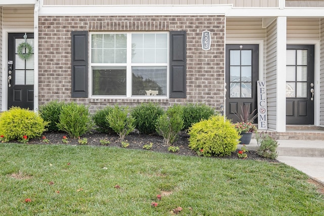 523 Moshe Flam Pl, La Vergne, TN 37086 - view of exterior entry featuring a lawn and brick siding