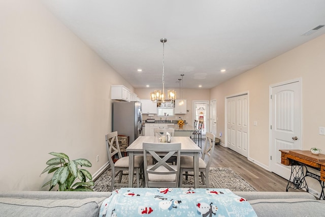 523 Moshe Flam Pl, La Vergne, TN 37086 - dining room with a chandelier, light wood-type flooring, and recessed lighting