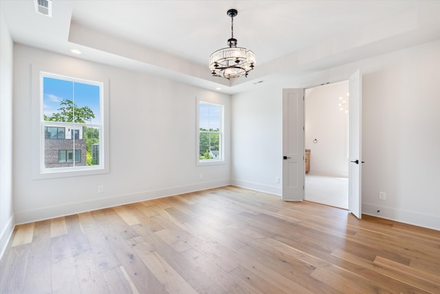 1135 Delmas Ave, Nashville, TN 37216 - spare room with a chandelier, healthy amount of natural light, light wood-type flooring, recessed lighting, and a tray ceiling