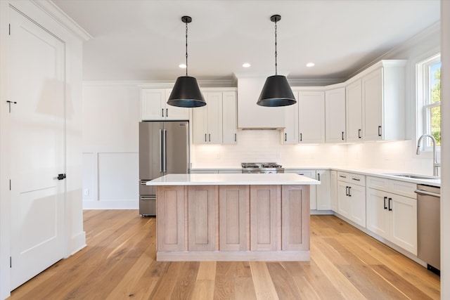 1135 Delmas Ave, Nashville, TN 37216 - kitchen with stainless steel appliances, a kitchen island, light countertops, backsplash, and white cabinets