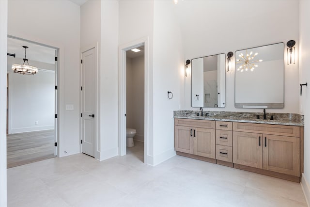1135 Delmas Ave, Nashville, TN 37216 - bathroom with a chandelier, a high ceiling, double vanity, and tile patterned floors