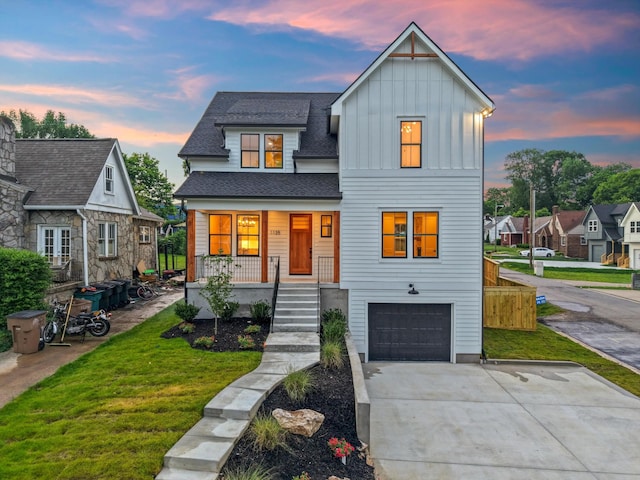 1135 Delmas Ave, Nashville, TN 37216 - view of front of home with board and batten siding, an attached garage, covered porch, a front yard, and roof with shingles