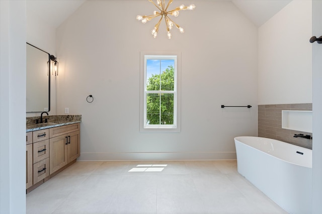 1135 Delmas Ave, Nashville, TN 37216 - full bathroom featuring lofted ceiling, vanity, a freestanding tub, and a chandelier