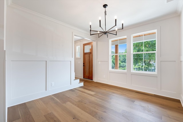 1135 Delmas Ave, Nashville, TN 37216 - unfurnished dining area with a decorative wall, a chandelier, light wood-style floors, ornamental molding, and a wainscoted wall
