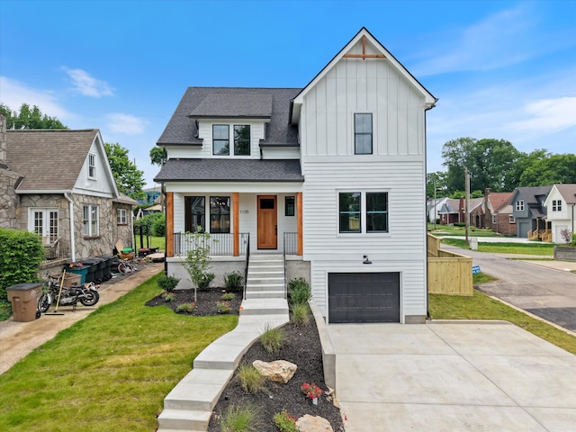 1135 Delmas Ave, Nashville, TN 37216 - modern farmhouse style home featuring board and batten siding, a garage, a porch, a front lawn, and roof with shingles