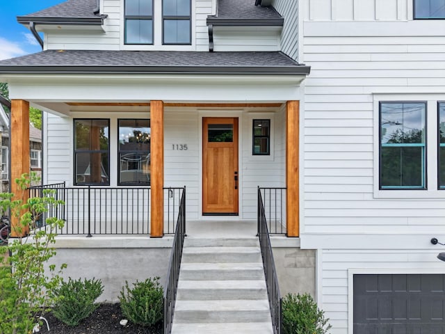 1135 Delmas Ave, Nashville, TN 37216 - entrance to property featuring a shingled roof, a porch, and a garage