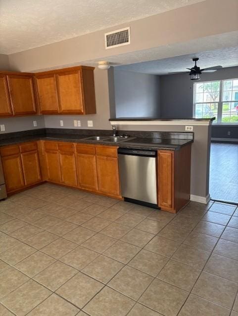 348 Arapaho Dr, Murfreesboro, TN 37128 - kitchen with stainless steel dishwasher, brown cabinets, a textured ceiling, and dark countertops