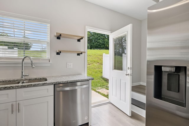 344 Kristen Ct, Columbia, TN 38401 - kitchen featuring stainless steel appliances, healthy amount of natural light, light wood-type flooring, and light stone counters