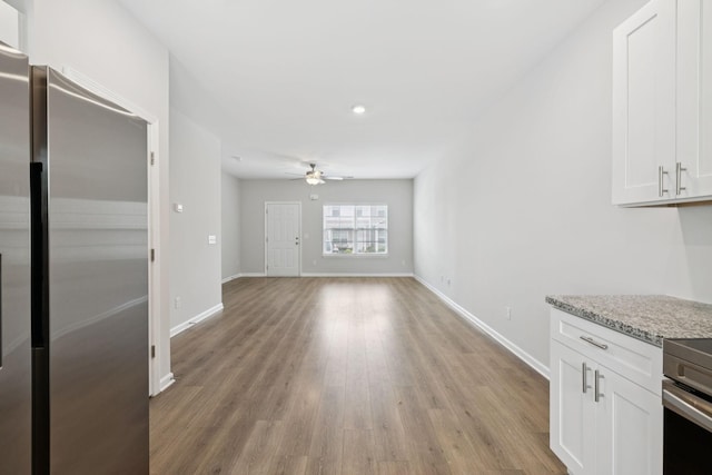 344 Kristen Ct, Columbia, TN 38401 - kitchen featuring freestanding refrigerator, ceiling fan, white cabinets, light wood-style flooring, and light stone countertops