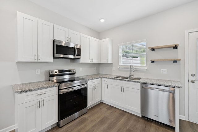 344 Kristen Ct, Columbia, TN 38401 - kitchen featuring stainless steel appliances, white cabinetry, dark wood-style flooring, light stone countertops, and recessed lighting