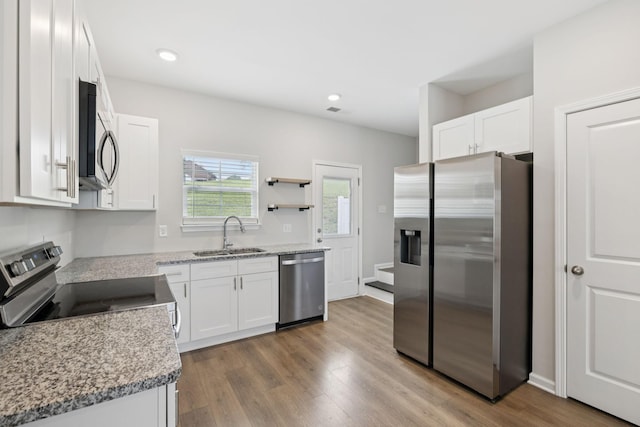 344 Kristen Ct, Columbia, TN 38401 - kitchen with appliances with stainless steel finishes, white cabinets, wood finished floors, and recessed lighting