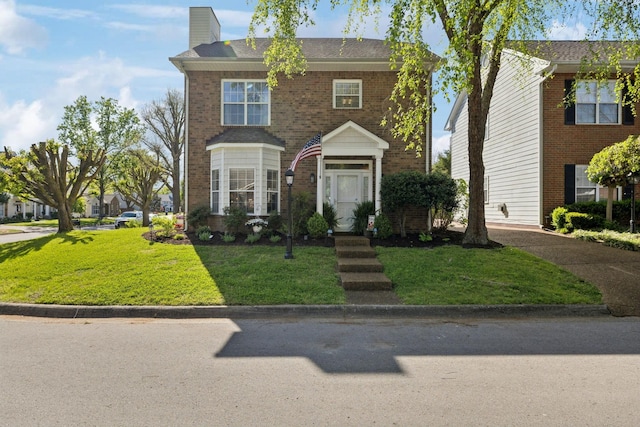 2016 Roderick Cir, Franklin, TN 37064 - view of front facade with a chimney, a front lawn, and brick siding