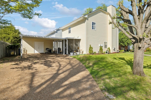 2016 Roderick Cir, Franklin, TN 37064 - rear view of house with asphalt driveway, a chimney, a carport, and a sunroom