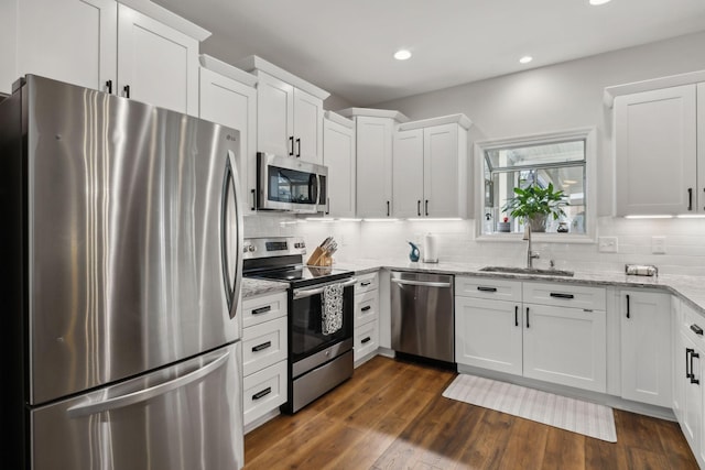 2016 Roderick Cir, Franklin, TN 37064 - kitchen featuring stainless steel appliances, white cabinetry, decorative backsplash, and recessed lighting