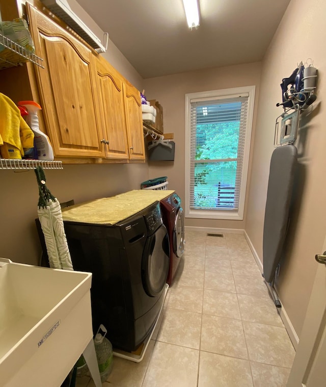 2214 Henpeck Ln, Franklin, TN 37064 - washroom with washing machine and clothes dryer, light tile patterned floors, and cabinet space