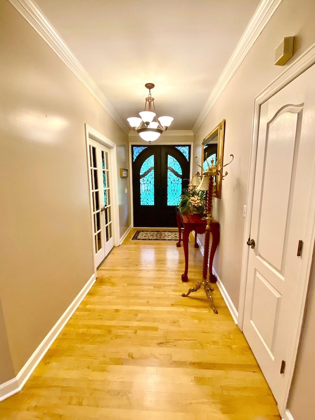 2214 Henpeck Ln, Franklin, TN 37064 - entrance foyer featuring a chandelier, french doors, light wood finished floors, and crown molding