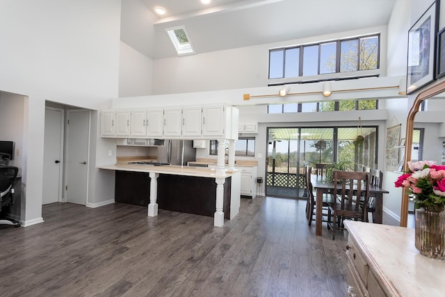175 Twitty Rd, Dunlap, TN 37327 - kitchen with a towering ceiling, light countertops, freestanding refrigerator, white cabinets, and a kitchen breakfast bar