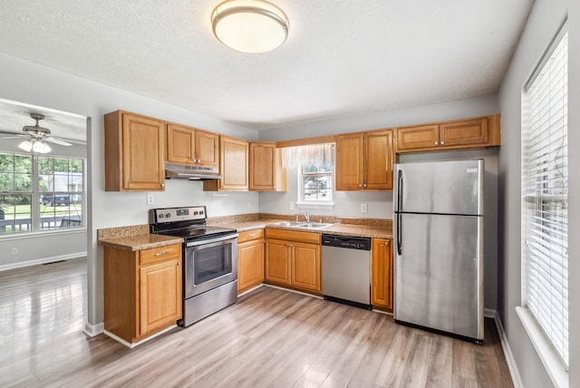 643 Artic Ave, Oak Grove, KY 42262 - kitchen featuring stainless steel appliances, under cabinet range hood, light wood-style floors, a ceiling fan, and light countertops