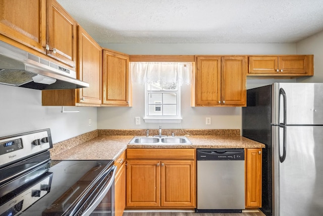 643 Artic Ave, Oak Grove, KY 42262 - kitchen featuring appliances with stainless steel finishes, under cabinet range hood, a textured ceiling, brown cabinets, and light countertops