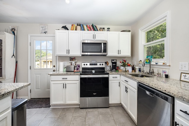 100 Beech St, Columbia, TN 38401 - kitchen featuring stainless steel appliances, healthy amount of natural light, and white cabinets