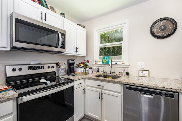 100 Beech St, Columbia, TN 38401 - kitchen featuring appliances with stainless steel finishes, white cabinets, and light stone countertops