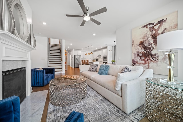 805 Dunbar Ct, Goodlettsville, TN 37072 - living room featuring wood finished floors, a ceiling fan, stairs, recessed lighting, and a premium fireplace