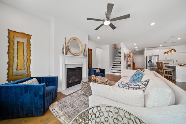 805 Dunbar Ct, Goodlettsville, TN 37072 - living room featuring stairs, a high end fireplace, a ceiling fan, wood finished floors, and recessed lighting