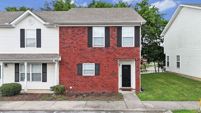 912 Patty Cv, La Vergne, TN 37086 - view of front of house with a front yard, brick siding, and a shingled roof
