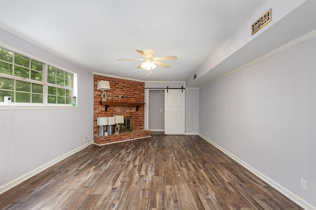 3516 Saxon Mist Ct, Nashville, TN 37217 - unfurnished living room featuring a ceiling fan, hardwood / wood-style floors, a barn door, and crown molding