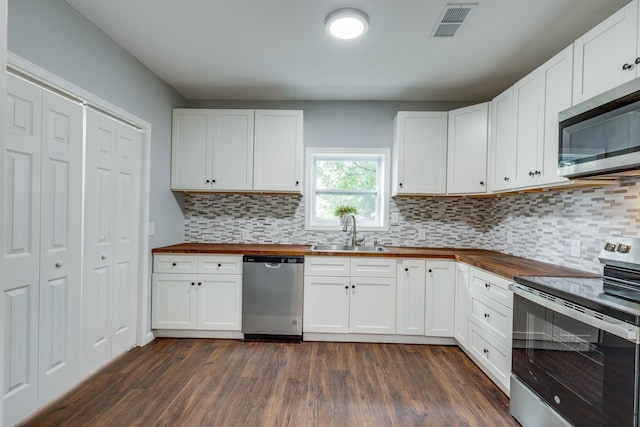 1689 Sumac Rd, Pulaski, TN 38478 - kitchen with wood counters, stainless steel appliances, dark wood-type flooring, and decorative backsplash