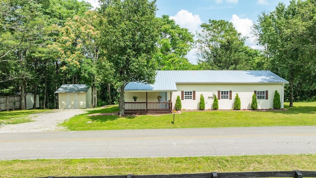 1689 Sumac Rd, Pulaski, TN 38478 - view of front facade with a front yard, a metal roof, a storage unit, a porch, and driveway