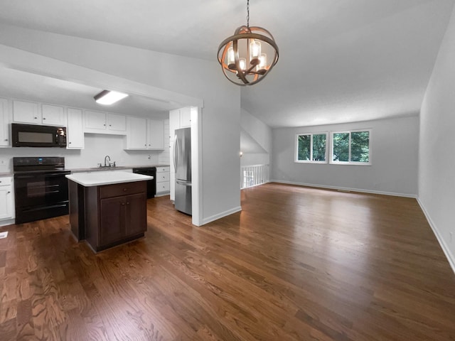 7120 Sutton Pl, Fairview, TN 37062 - kitchen with black appliances, open floor plan, a chandelier, light countertops, and white cabinetry