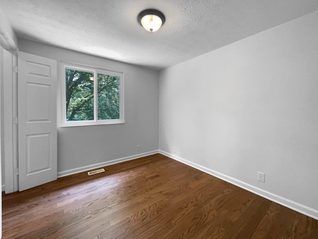 7120 Sutton Pl, Fairview, TN 37062 - spare room with a textured ceiling and dark wood-style flooring