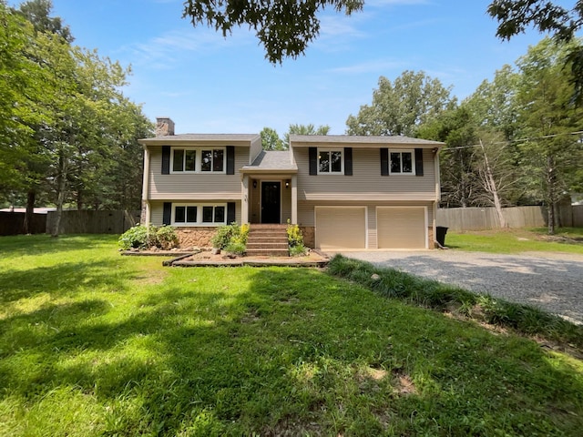 7120 Sutton Pl, Fairview, TN 37062 - split foyer home featuring a chimney, gravel driveway, and a garage