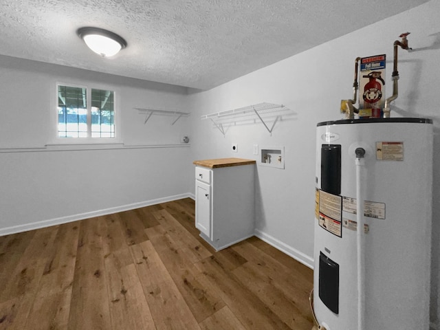 7120 Sutton Pl, Fairview, TN 37062 - washroom featuring electric water heater, hookup for an electric dryer, hookup for a washing machine, a textured ceiling, and wood finished floors