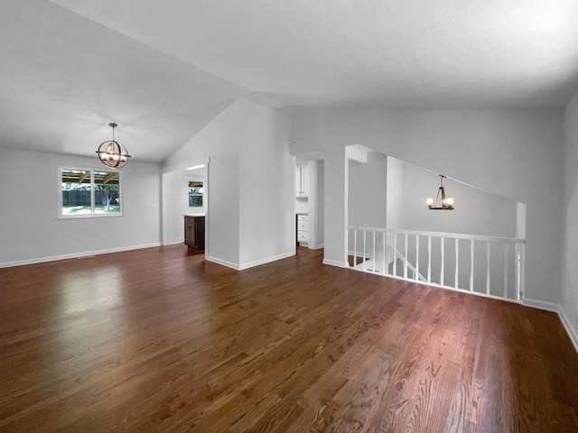 7120 Sutton Pl, Fairview, TN 37062 - unfurnished living room featuring a chandelier, lofted ceiling, and dark wood finished floors