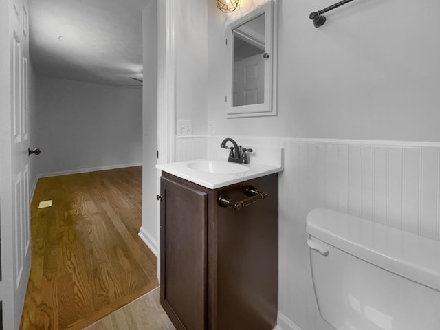 7120 Sutton Pl, Fairview, TN 37062 - bathroom with wood finished floors, vanity, and wainscoting