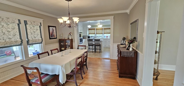 315 Seven Mile Ferry Rd, Cunningham, TN 37052 - dining space featuring a chandelier, ornamental molding, light wood-type flooring, and wainscoting