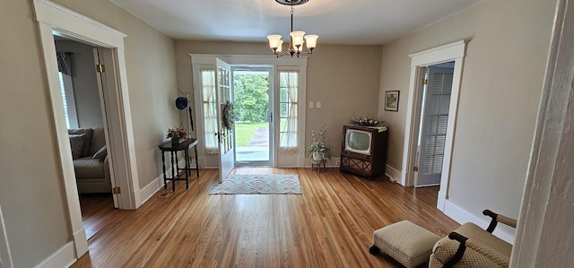 315 Seven Mile Ferry Rd, Cunningham, TN 37052 - doorway to outside featuring light wood-style floors and a chandelier
