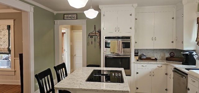 315 Seven Mile Ferry Rd, Cunningham, TN 37052 - kitchen with stainless steel appliances, crown molding, white cabinetry, decorative light fixtures, and wood finished floors