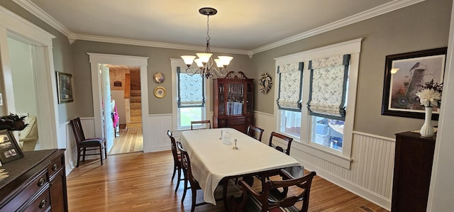 315 Seven Mile Ferry Rd, Cunningham, TN 37052 - dining room featuring wainscoting, healthy amount of natural light, light wood-style floors, a chandelier, and ornamental molding