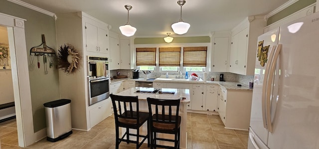 315 Seven Mile Ferry Rd, Cunningham, TN 37052 - kitchen with appliances with stainless steel finishes, white cabinetry, light countertops, crown molding, and backsplash