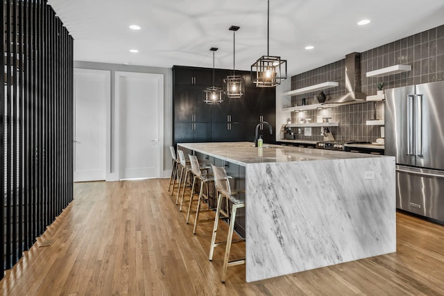 705 27th Ave N, Nashville, TN 37208 - kitchen with high quality fridge, modern cabinets, tasteful backsplash, a breakfast bar, and a spacious island