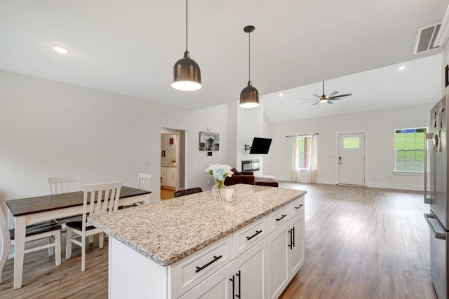 94 Hickory Ridge Ln, Woodbury, TN 37190 - kitchen with a center island, light wood-type flooring, decorative light fixtures, white cabinets, and ceiling fan