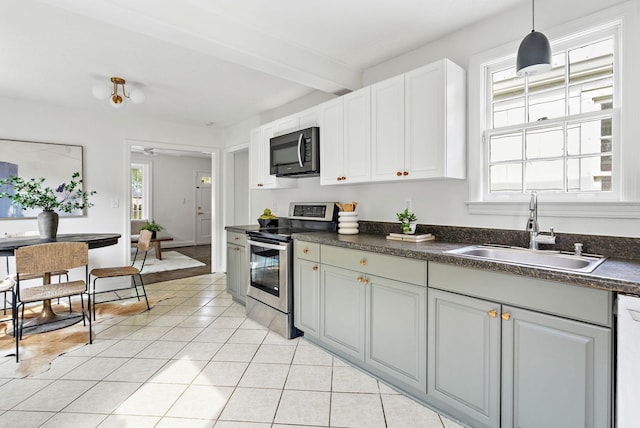 1203 Ardee Ave, Nashville, TN 37216 - kitchen with electric stove, dark countertops, light tile patterned floors, dishwasher, and beamed ceiling